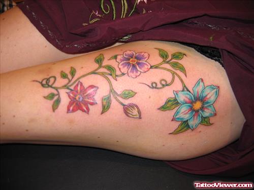 Colored Flowers Left Thigh Tattoo For Girls
