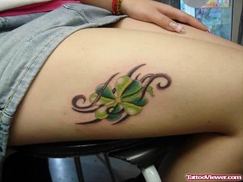 Tribal And Green Leaf Thigh Tattoo