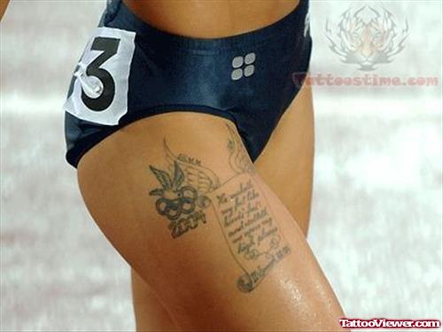 Olympic Logo and Scroll Tattoo On Right Thigh