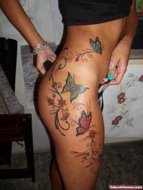 Girl Showing Her Thigh Tattoo With Colored Butterflies
