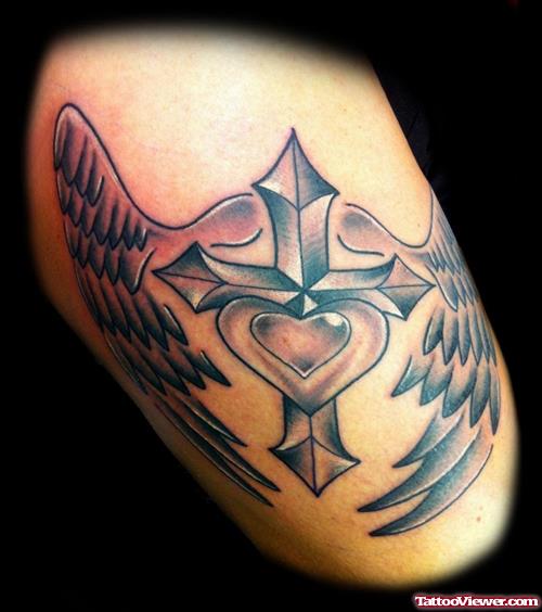 Grey Ink Winged Cross And Heart Thigh Tattoo