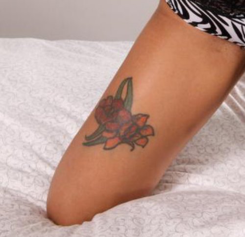 Tribal And Flowers Thigh Tattoo For Girls