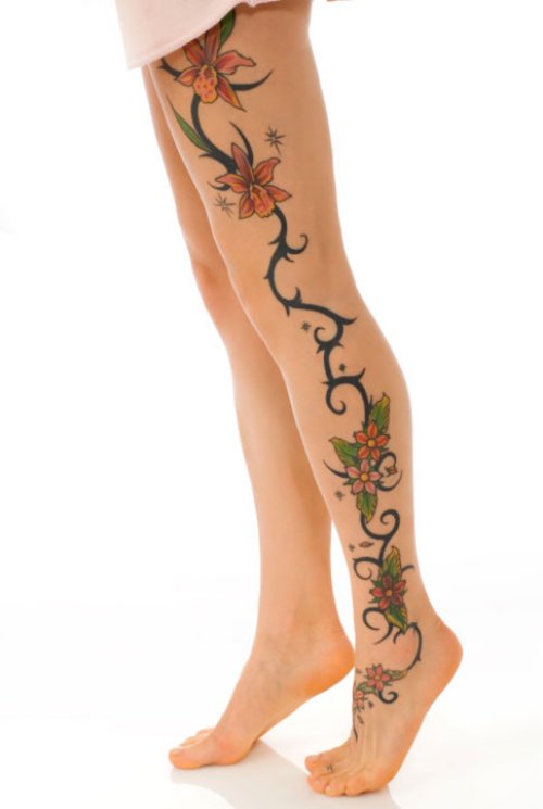 Tribal And Flowers Tattoo On Left Thigh