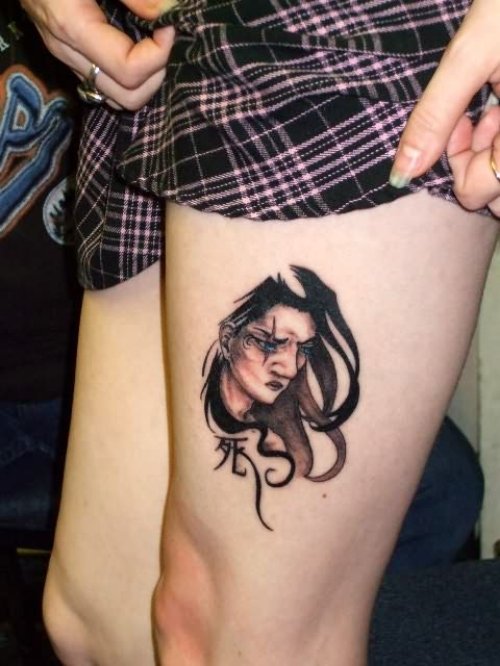 Girls Faces Tattoo On Thigh