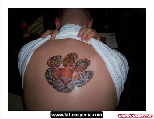 Tiger Face In Paw Print Tattoo On Back