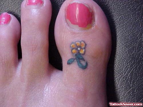 Tiny Flower Tattoo On Toe