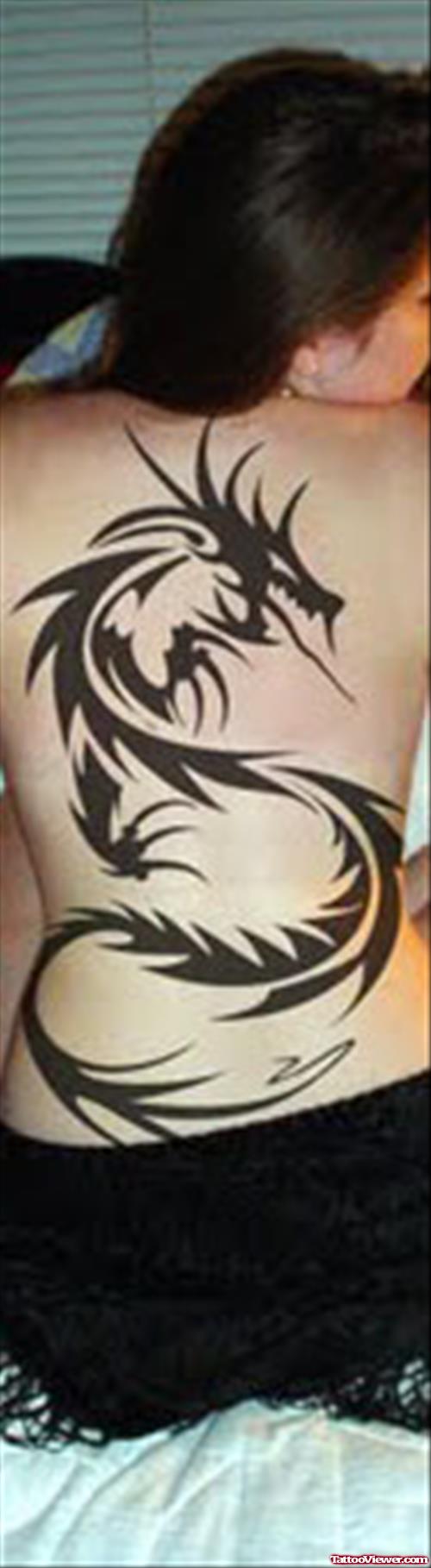 Black Ink Tribal Dragon Tattoo On Girl Back Body