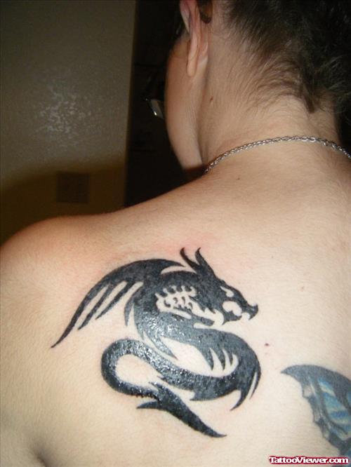 Black Ink Tribal Dragion Tattoo On Left Back Shoulder