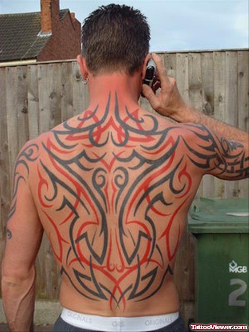 Red And Black Ink Tribal Tattoos On Man Back