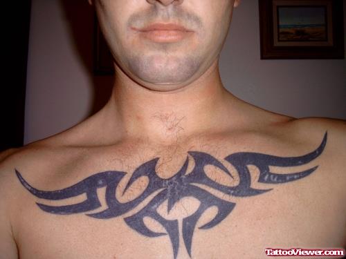 Amazing Black Ink Tribal Tattoo On Man Chest