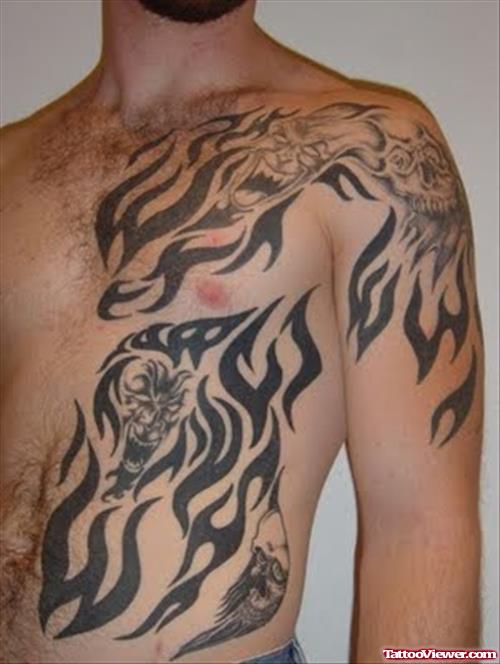 Tribal Tattoo On Man Chest and Left Shoulder