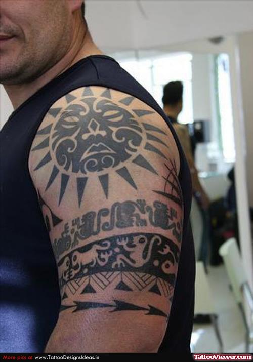 Black Ink Tribal Tattoos On Man Left Half Sleeve