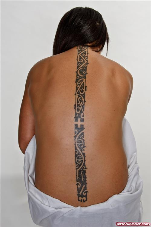 Black Ink Tribal Tattoo On Back Bone