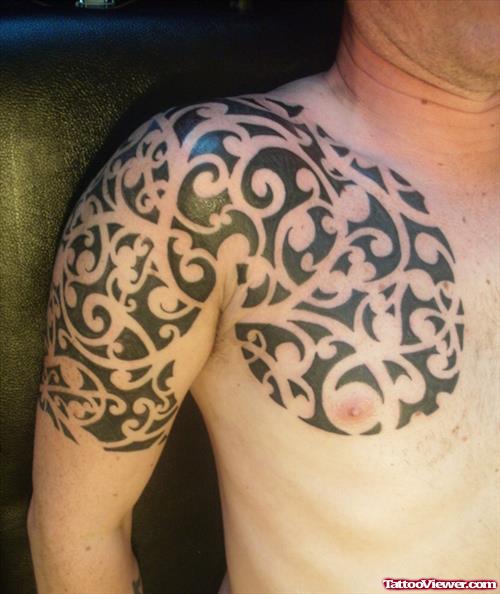 Maori Tribal Tattoo On Man Chest And Shoulder