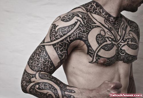 Maori Tribal Tattoo On Chest And Sleeve