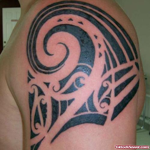 Black Ink Tribal Tattoo On Man Left Shoulder