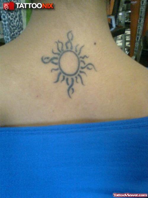 Attractive Tribal Sun Tattoo On Girl Upperback