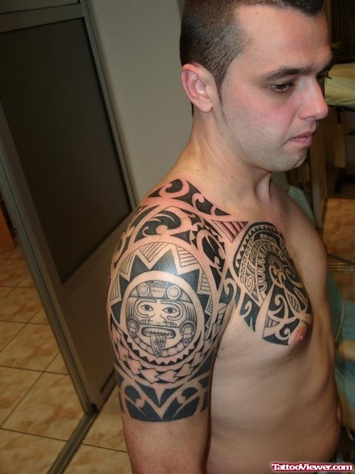 Maori Tribal Tattoo On Chest And Half Sleeve