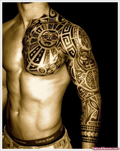 Black Ink Tribal Tattoo On Chest And Left Sleeve