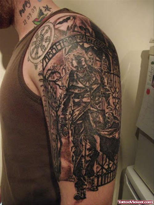 Black Ink Joker and Tribal Tattoo On Left Half Sleeve