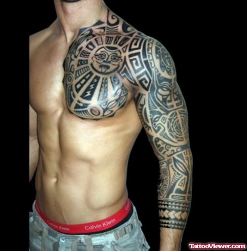 Amazing Tribal Tattoo On Chest And Left Sleeve