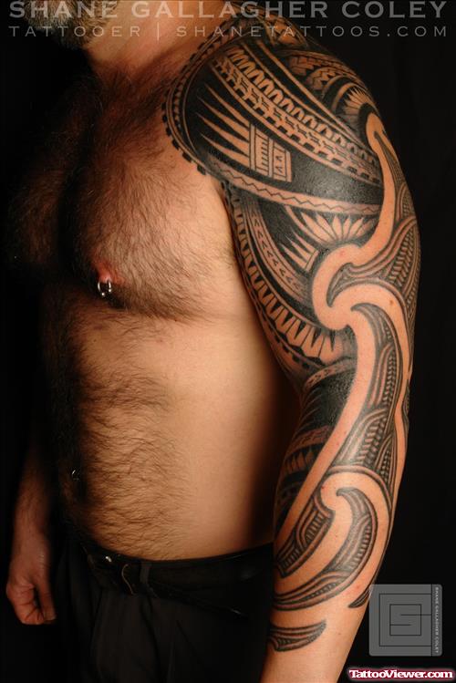 Man With Tribal Tattoo On Left Arm