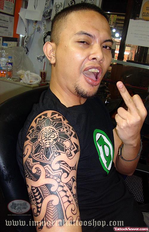 Man With Grey Ink Tribal Tattoo On Half Sleeve