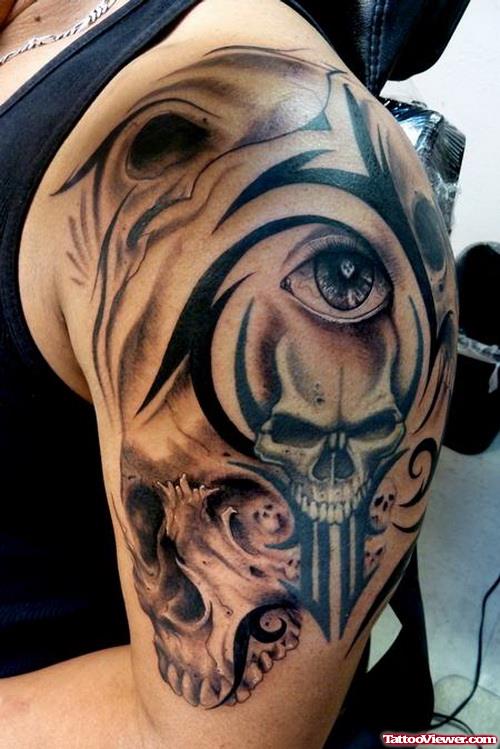 Grey Ink Skull and Tribal Tattoo On Man Left Shoulder