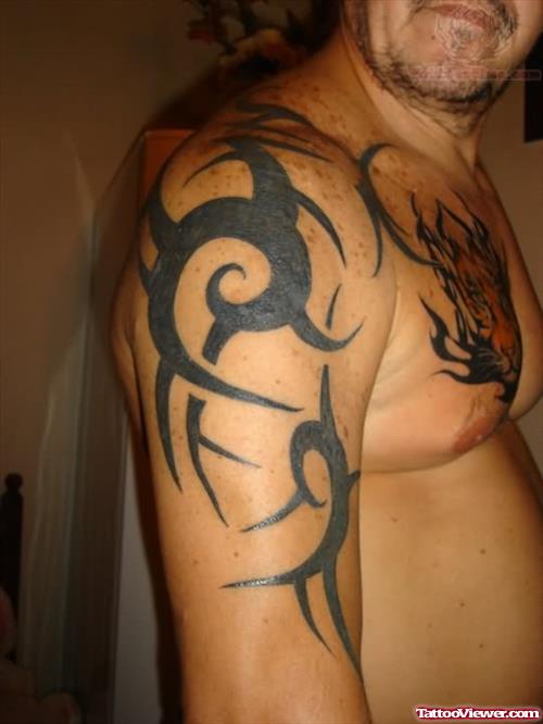 Tribal Tattoo On Men Bicep And Chest