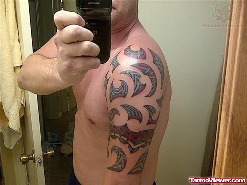Color ink Tribal Tattoo On Men Shoulder