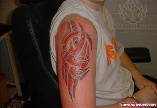 Red Tribal Tattoo On Bicep