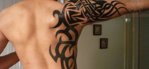 Tribal Tattoo On Side Rib And Half Sleeve
