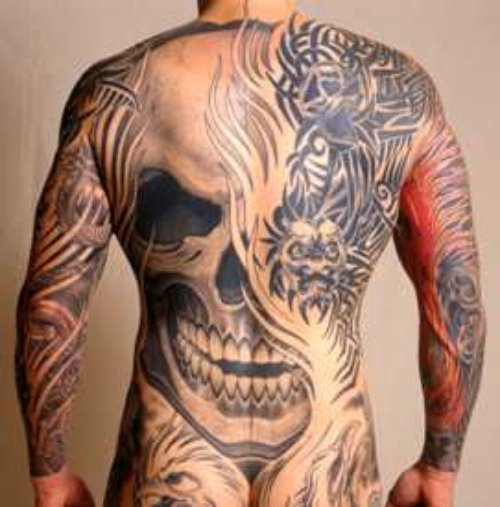 Grey Ink Skull And Tribal Tattoo On Back Body