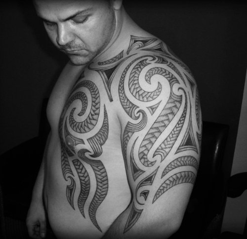 Polynesian Tribal Tattoo On Man Chest And Left Shoulder