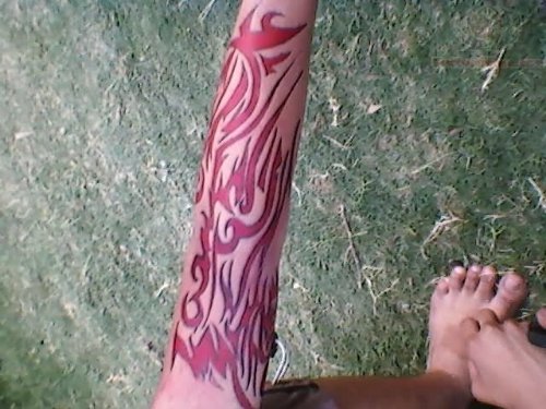 Red Tribal Tattoo On Arm