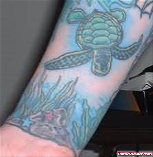 Sea And Turtle Swiming Tattoo On Arm