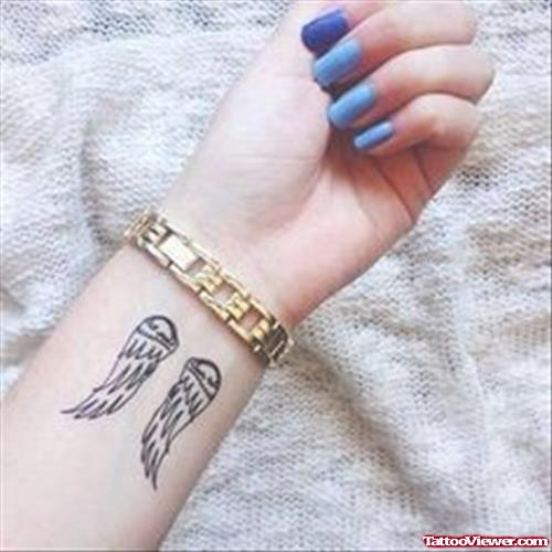 Small Angel Wings Tattoos On Left Wrist