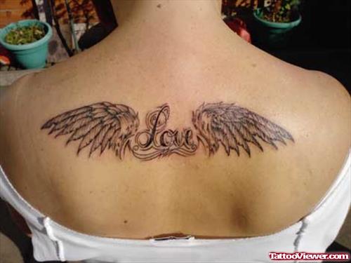 Grey Ink Wings Tattoo On Girl Upperback