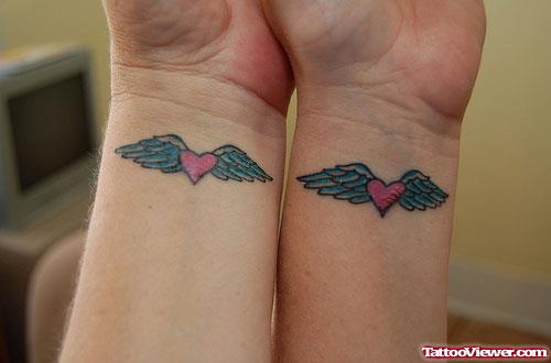 Winged Pink Heart Tattoos On Wrists