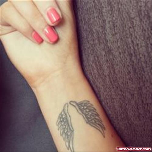 Grey Ink Wings Tattoos on Right Wrist