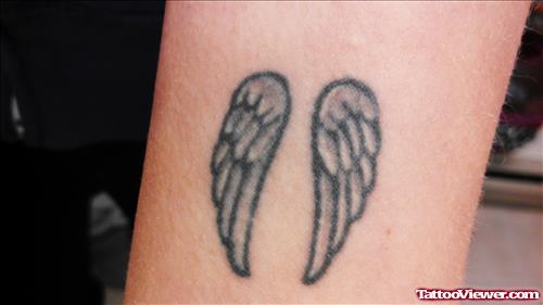 Grey ink Wings Tattoo on Bicep
