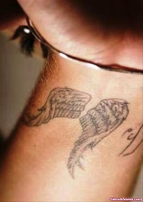 Grey Ink Wings Tattoos On Left Wrist