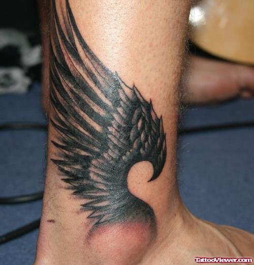 Grey Ink Wings Tattoo On Ankle