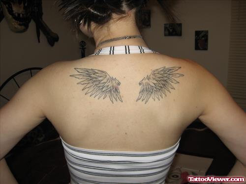 Grey Ink Wings Tattoos On Girl Upperback