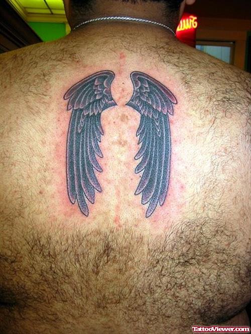 Black Ink Wings Tattoo On Upperback