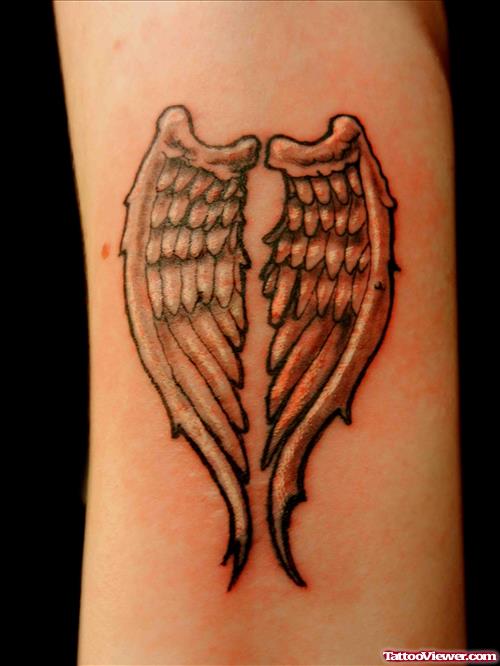 Grey Ink Wings Tattoo On Forearm