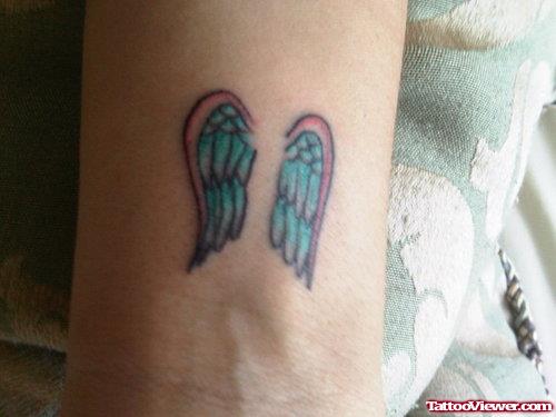 Blue Ink Angel Wing Tattoo on Bicep