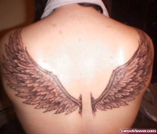 Attractive Grey Ink Wings Tattoo On Back