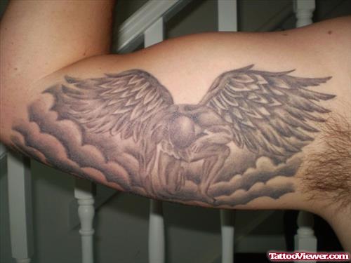 Grey Ink Wing Tattoo On Right Biceps