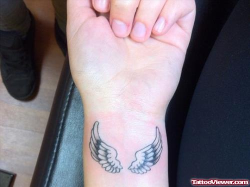 Little Grey Ink Wings Tattoo